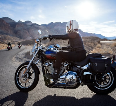 man riding touring motorcycle during daytime