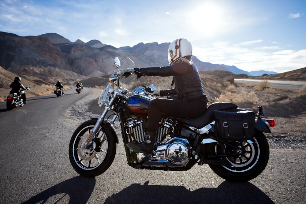 man riding touring motorcycle during daytime