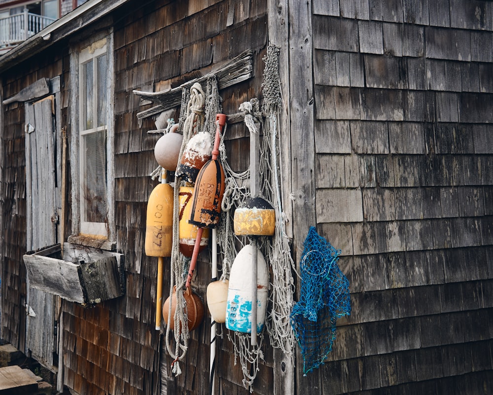 fishing buoys hanging on house wall