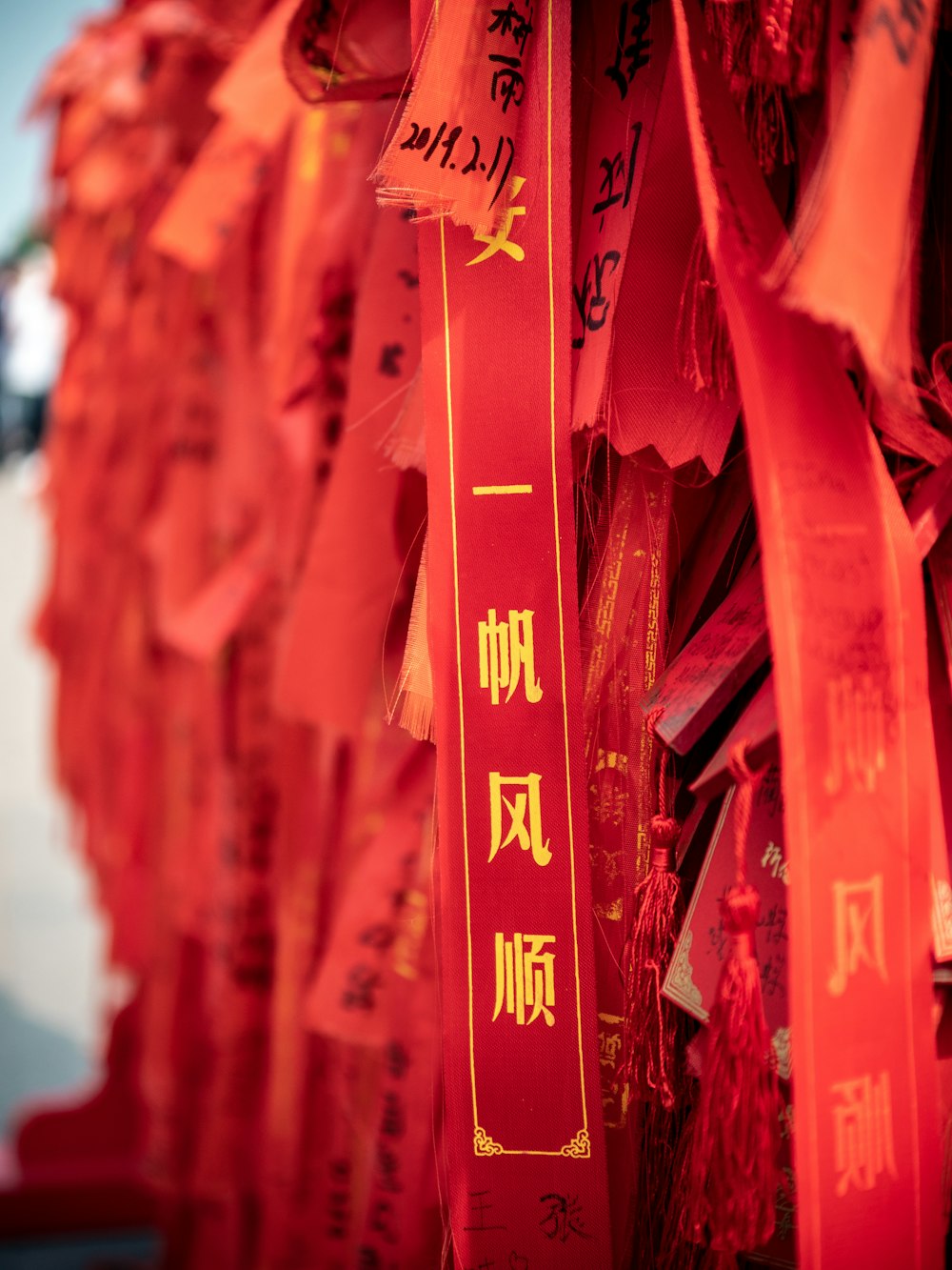 a row of red ribbons with chinese writing on them