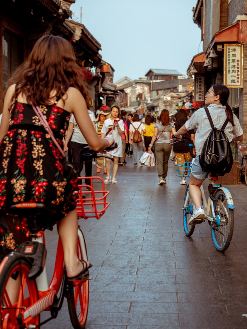woman wearing dress riding bicycle