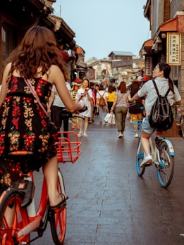 woman wearing dress riding bicycle