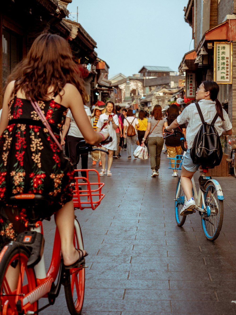 woman wearing dress riding bicycle