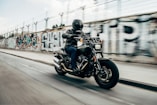 person riding motorcycle on concrete road
