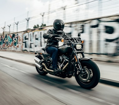 person riding motorcycle on concrete road