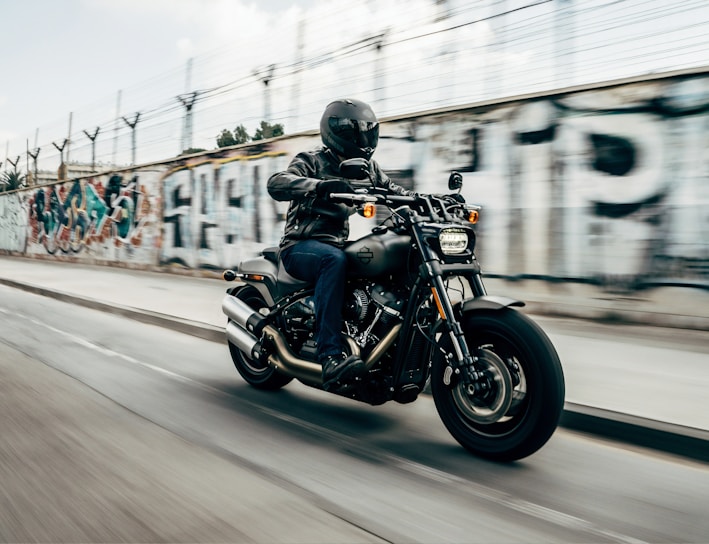 person riding motorcycle on concrete road