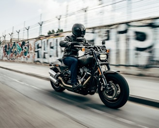 person riding motorcycle on concrete road