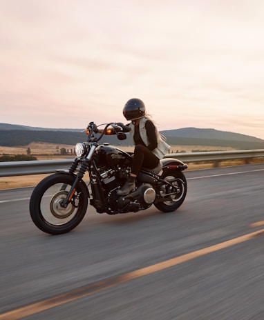man on black cruiser motorcycle in highway