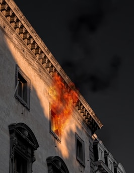 fire coming from window of concrete building