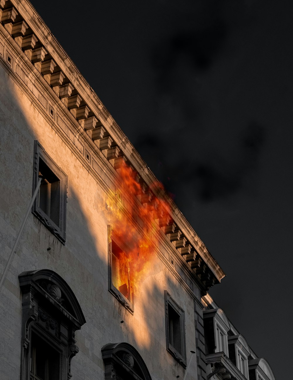 fire coming from window of concrete building