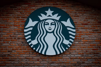 Starbucks logo signage on brown brick wall