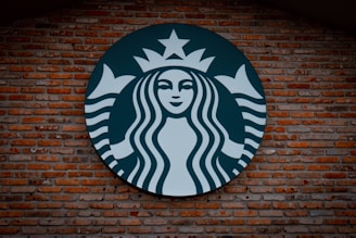 Starbucks logo signage on brown brick wall