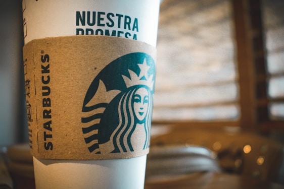 A vibrant coffee passport card with NFC symbol glowing, surrounded by coffee cups from various Puebla cafés.