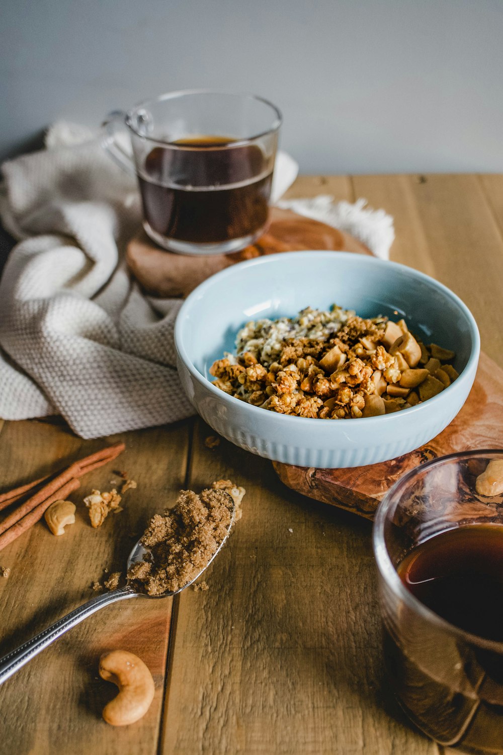 nuts in bowl beside liquid-filled cup