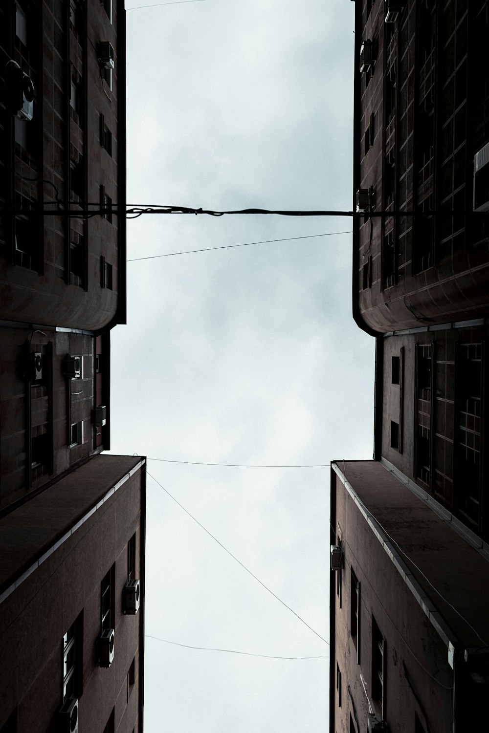 brown concrete building under white clouds during daytime