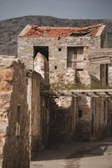 Expert examining moisture damage on a building wall in a mountainous Allgäu village.