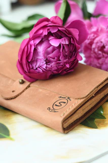 Close-up of a richly textured leather wallet embossed with a distelfink bird design