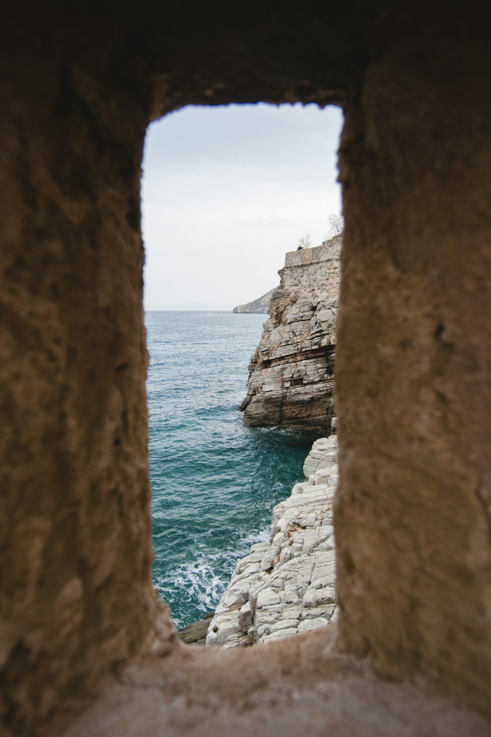 coastal area through stone wall hole