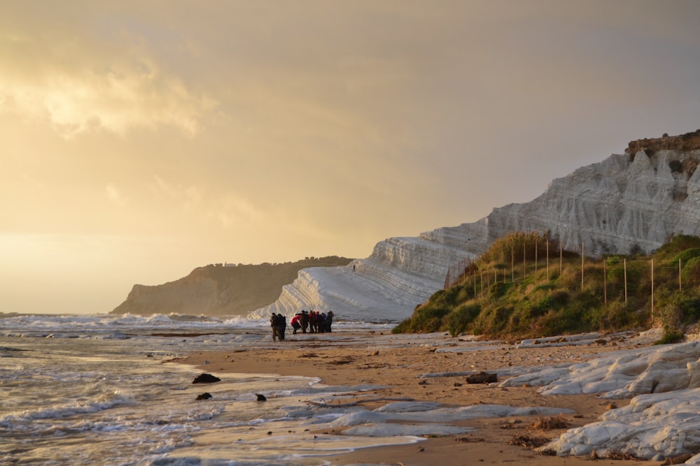 people strolling across the beach