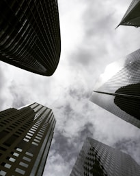 high angle photography of glass walled building under white and gray skies