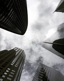 high angle photography of glass walled building under white and gray skies