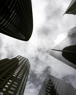 high angle photography of glass walled building under white and gray skies