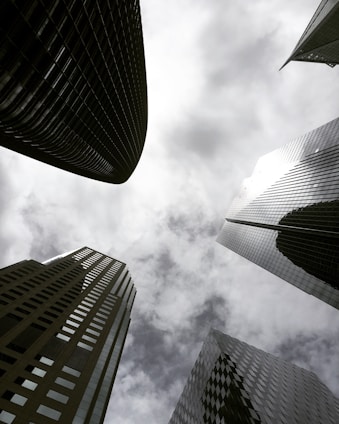 high angle photography of glass walled building under white and gray skies