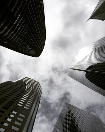 high angle photography of glass walled building under white and gray skies