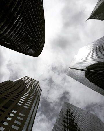 high angle photography of glass walled building under white and gray skies