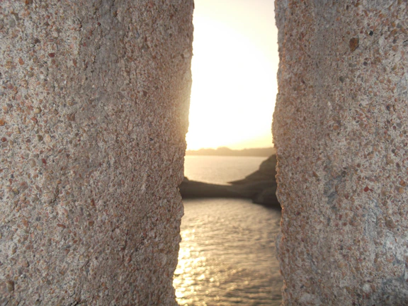 Sunset casting warm hues over natural stone and wood wellness spaces