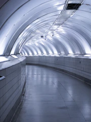 A sleek pneumatic tube system delivering groceries swiftly inside a modern gated society.