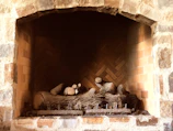 Brick masonry work on a newly built fireplace in a cozy living room.