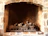 Close-up of a beautifully crafted brick fireplace inside a cozy living room.