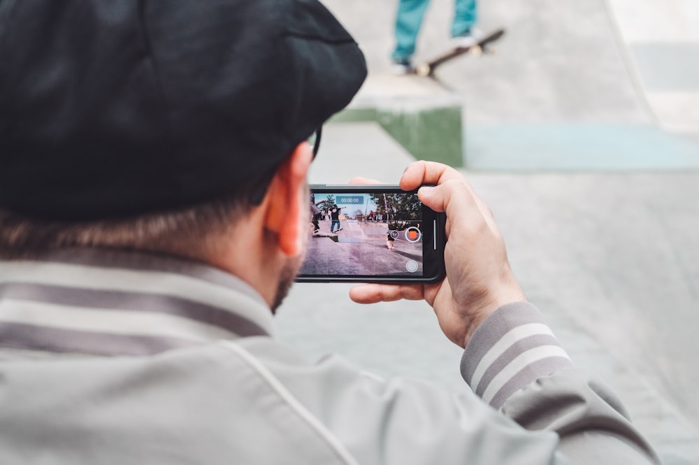 person taking photo frame phone