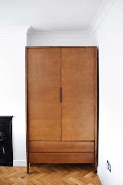 A sleek modular wardrobe with warm wooden finishes and integrated LED lighting.
