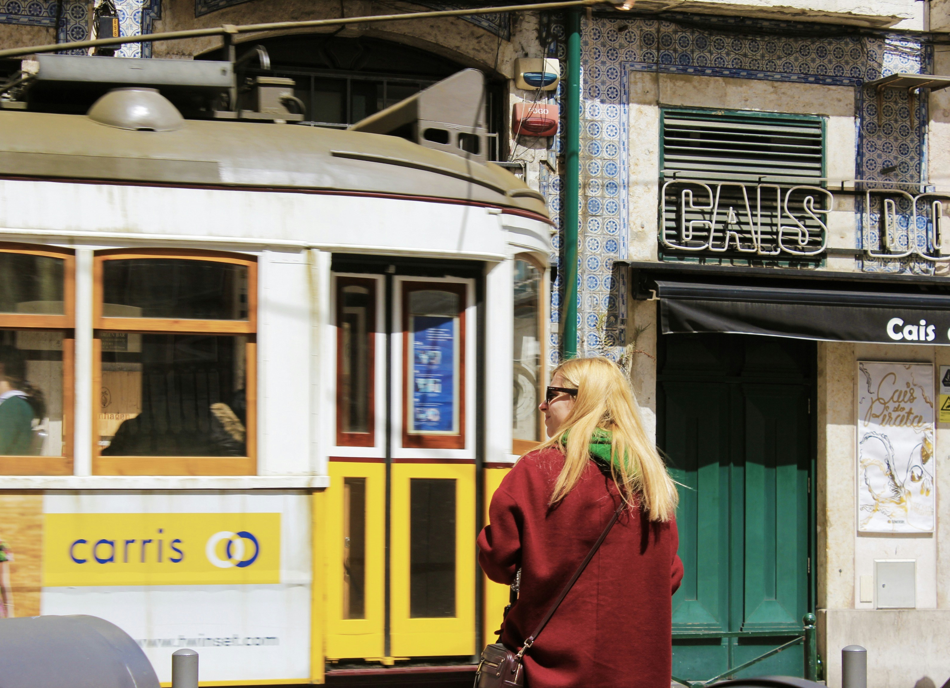 Lisbon street scene with a traveler near a vehicle