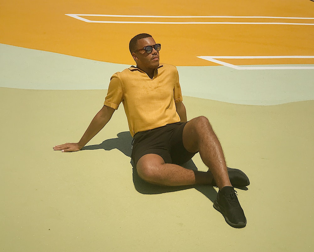 man sitting on brown floor