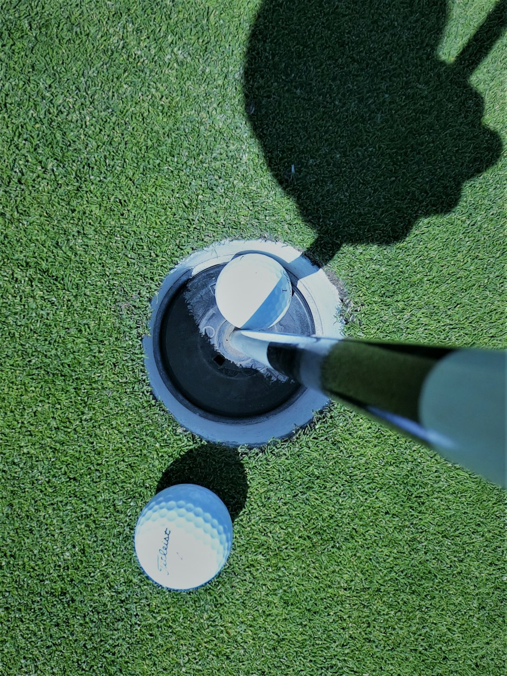white golf ball on goal hole