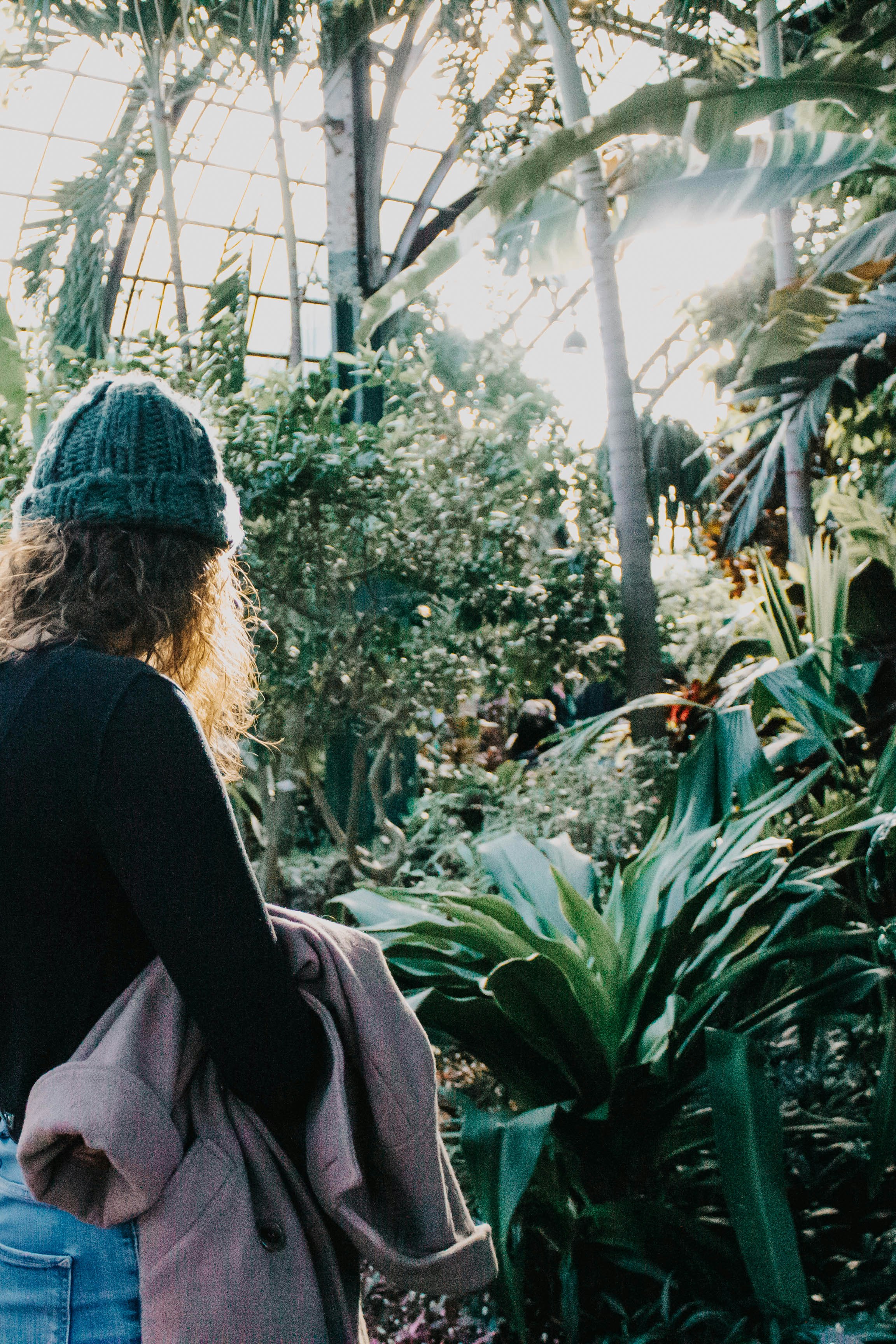 woman standing beside plants