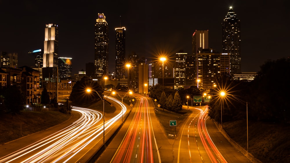 time lapse photography of street and buildings during night time