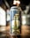 A can of beer is prominently displayed on a wooden surface, featuring a label with a gold illustration of a tower and a hop. Various colorful symbols resembling flags are scattered across the design. The background is blurred, with soft lighting creating a warm atmosphere.