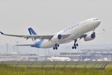 white and blue airplane about to fly at the airport