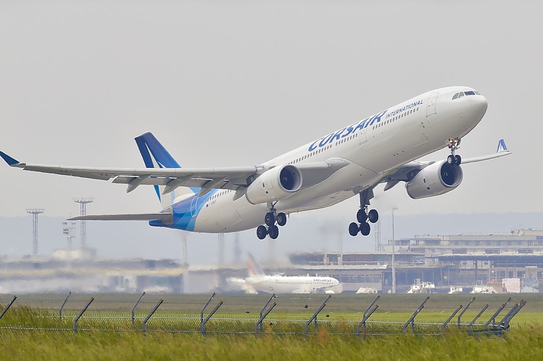 white and blue airplane about to fly at the airport, A330 of Corsair taking off