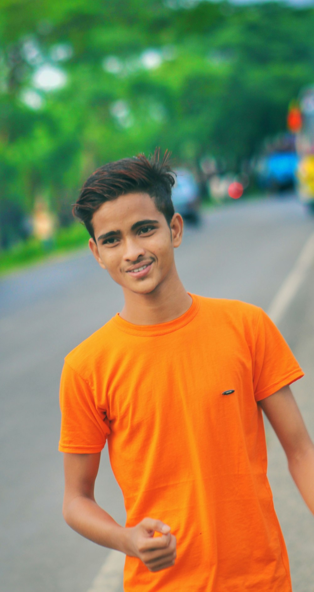 smiling man wearing orange shirt