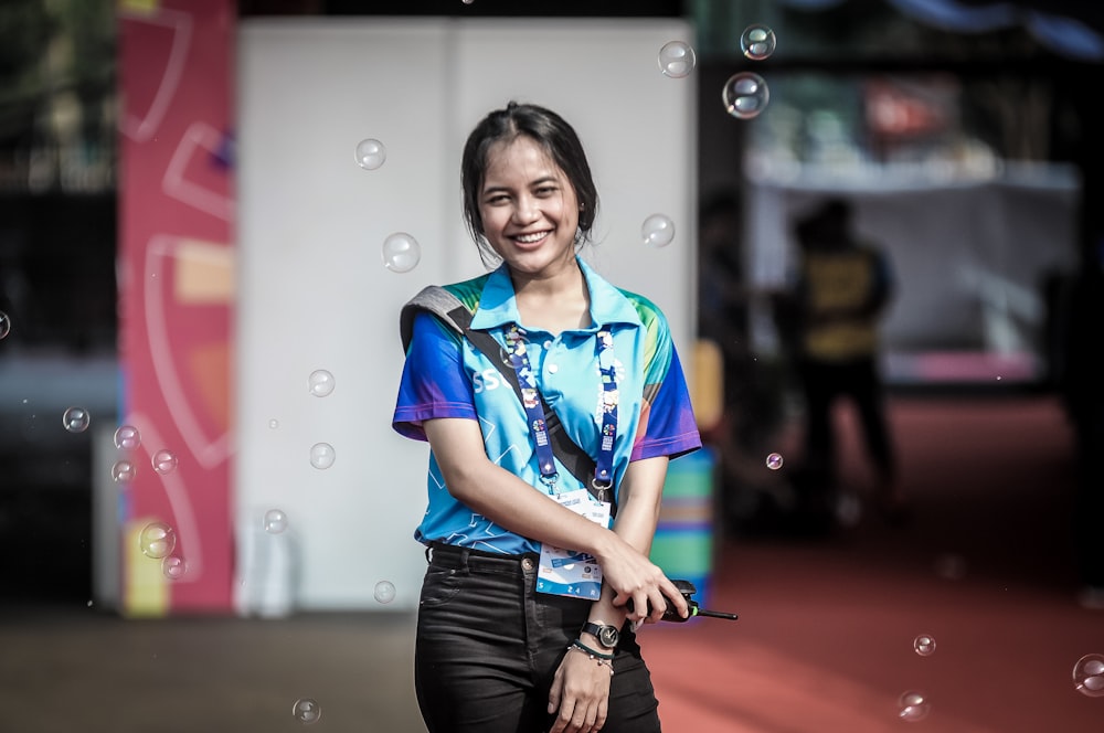 smiling girl standing near building