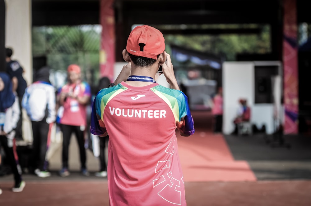 person standing wearing red shirt