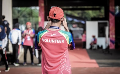 person standing wearing red shirt