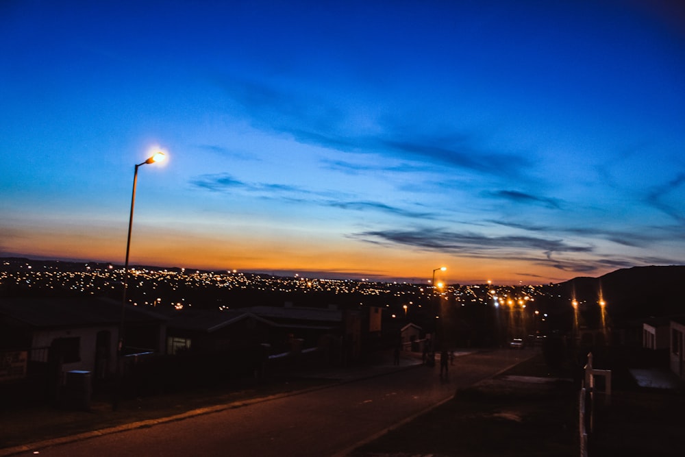 light posts turned-on on streets during nighttime