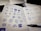 Close-up of hands sketching logo concepts on paper with colorful markers.