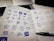 A graphic designer sketching logo concepts on a notepad with colorful markers.
